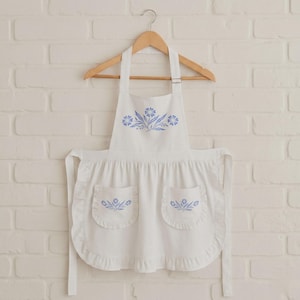 blue cornflower apron,corningware kitchen,retro blue kitchen,vintage blue apron,farmhouse kitchen wear,cottagecore kitchen,vintage floral apron,blue farmhouse decor,retro cooking apron,classic kitchen apron,shabby chic kitchen,blue apron gift idea,vintage homemaker apron,floral kitchen apron,retro kitchen gift idea,apron for baking,cute apron for mom,traditional apron,blue floral kitchen,apron for cooking