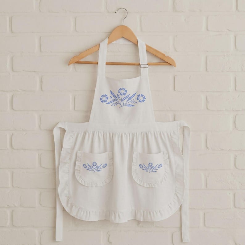 blue cornflower apron,corningware kitchen,retro blue kitchen,vintage blue apron,farmhouse kitchen wear,cottagecore kitchen,vintage floral apron,blue farmhouse decor,retro cooking apron,classic kitchen apron,shabby chic kitchen,blue apron gift idea,vintage homemaker apron,floral kitchen apron,retro kitchen gift idea,apron for baking,cute apron for mom,traditional apron,blue floral kitchen,apron for cooking