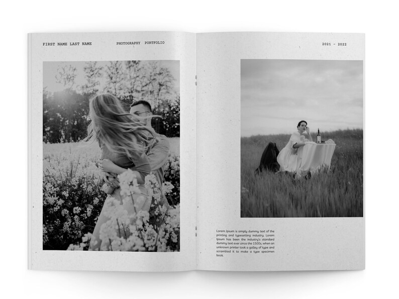 May include: A black and white photo of a couple in a field of flowers. The woman is holding onto the man's shoulders and her hair is blowing in the wind. The man is looking at the camera.
