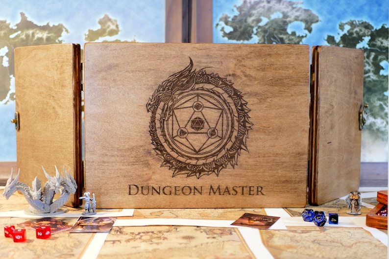 May include: A wooden Dungeon Master screen with a dragon and geometric design, the words "Dungeon Master" are engraved on the front.