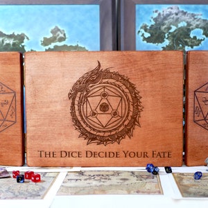 May include: A wooden box with three hinged panels. The center panel features a dragon design with the text "The Dice Decide Your Fate". The side panels each have a 20-sided die engraved on them.