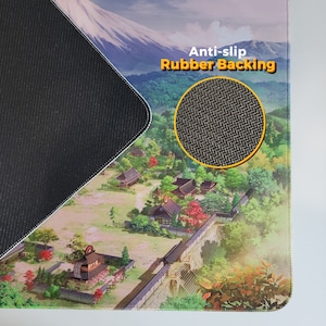 May include: A black mousepad with a Japanese-inspired design featuring a mountain range and a village. The mousepad has a textured rubber backing with the text "Anti-slip Rubber Backing" printed on it.