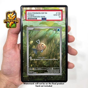 May include: A Pokemon trading card featuring Feebas, a water-type Pokemon, in a green and brown background. The card is a basic card with a power of 30. The card is a 2024 Pokemon SSP EN Illustration Rare card with a Gem Mint 10 rating.