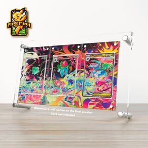 May include: A clear acrylic display frame featuring three vertical slots for trading cards, decorated with a vibrant, multi-colored abstract floral background. The frame is held together by four silver metal standoffs at the corners.