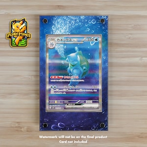 May include: A blue and white Pokemon card featuring a blue turtle-like creature with the Japanese text "カメックスEX" and "330" on the card. The card is in a clear plastic frame with a blue background.