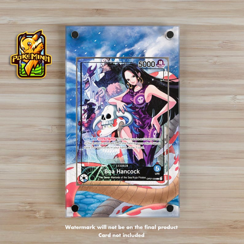 May include: A clear acrylic display featuring a One Piece trading card with Boa Hancock. The card has a purple and white design with a skull and the number 5000. The display is on a light brown surface.