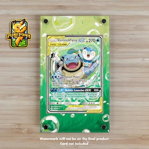 May include: A green and blue Pokemon trading card featuring Blastoise & Piplup, a Tag Team card with a HP of 270. The card has two attacks: Splash Maker and Bubble Launcher GX. The card is surrounded by a green and blue background with bubbles.