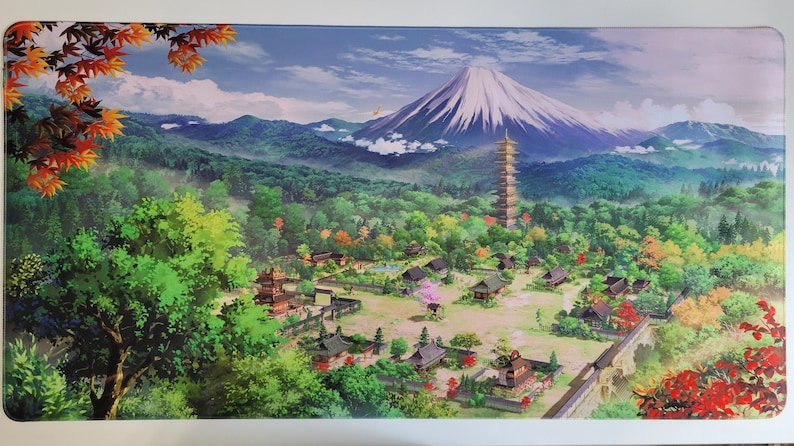 May include: A colorful illustration of a Japanese village with a pagoda, traditional houses, and a mountain in the background. The scene is set in a lush green forest with a blue sky and white clouds.