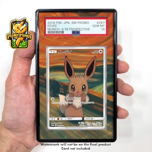 Peut inclure: Une carte à collectionner Pokémon encadrée avec Eevee de la série Munch: A Retrospective. La carte est notée GEM MT 10 et comprend du texte japonais. Le cadre a une bordure noire et un fond coloré. La carte est tenue dans une main.