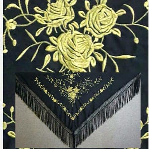 May include: A black triangular shawl featuring intricate gold-colored floral embroidery of roses and vines. The edges of the shawl are finished with long, thin black fringe that hangs from the bottom border, creating a decorative textile piece.