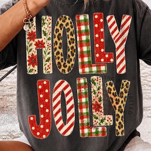 Holly Jolly text design in floral, leopard, and gingham plaid patchwork letters on black shirt