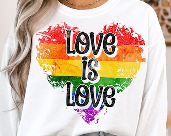 May include: White long-sleeve sweatshirt with a rainbow heart graphic and the text "Love is Love".