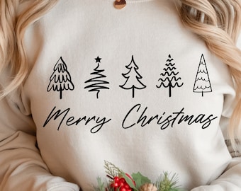 Könnte beinhalten: Ein beiger Pullover mit einer schwarzen Grafik von fünf stilisierten Weihnachtsbäumen und dem Text "Merry Christmas".