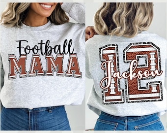 May include: Two gray sweatshirts with a football theme. One sweatshirt has the text "Football Mama" in black with brown football stitching. The other sweatshirt has a large brown football number "12" with the text "Jackson" in white.