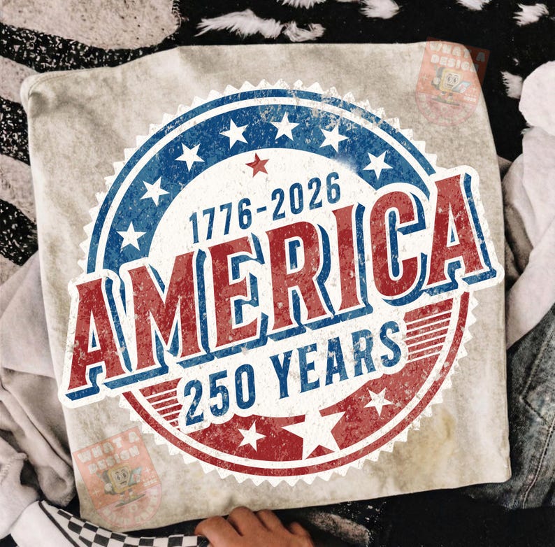May include: A light-colored pillow with a distressed graphic celebrating 250 years of America. The design features a red, white, and blue circular emblem with the text "AMERICA" and the years "1776-2026".