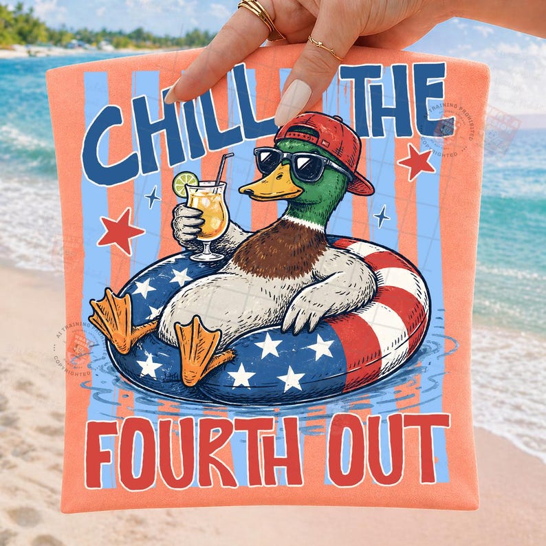 May include: A peach-colored graphic tee with the words "CHILL THE FOURTH OUT" in blue and white. The design features a cartoon duck wearing sunglasses and a red cap, floating in an inner tube with a cocktail.