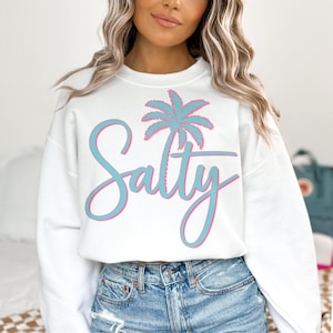 May include: White sweatshirt with a blue and pink palm tree graphic and the text "Salty" in a blue and pink script font.