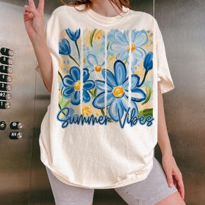 May include: A white t-shirt with a blue and yellow floral design and the text "Summer Vibes".