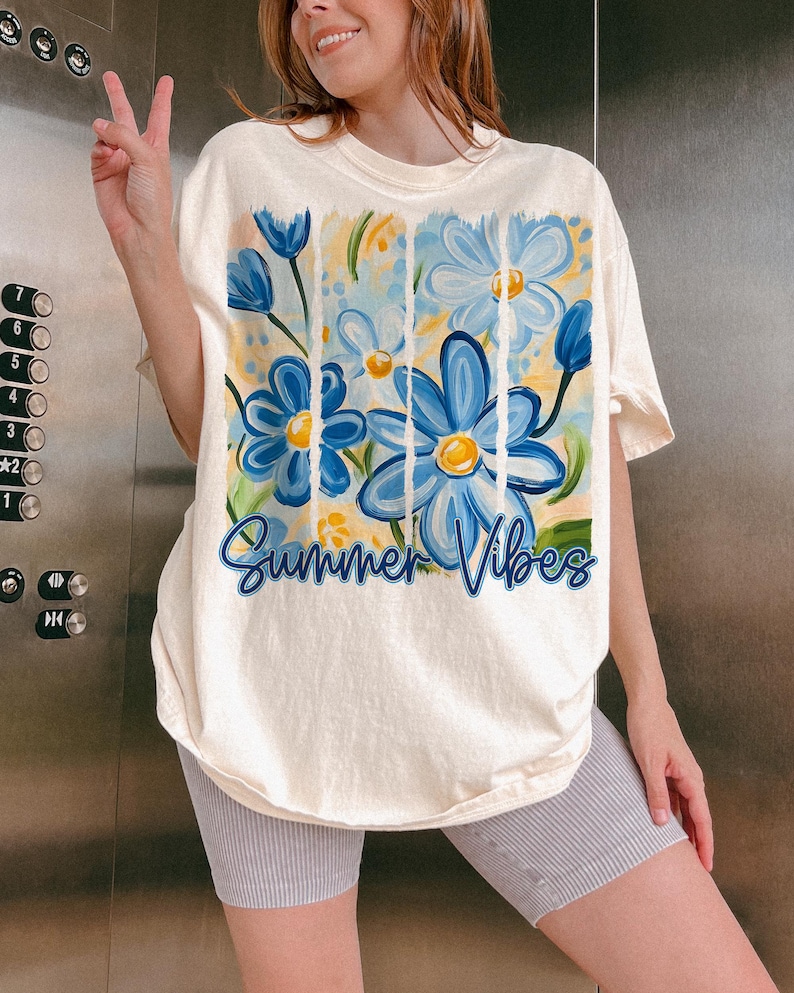 May include: A white t-shirt with a blue and yellow floral design and the text "Summer Vibes".