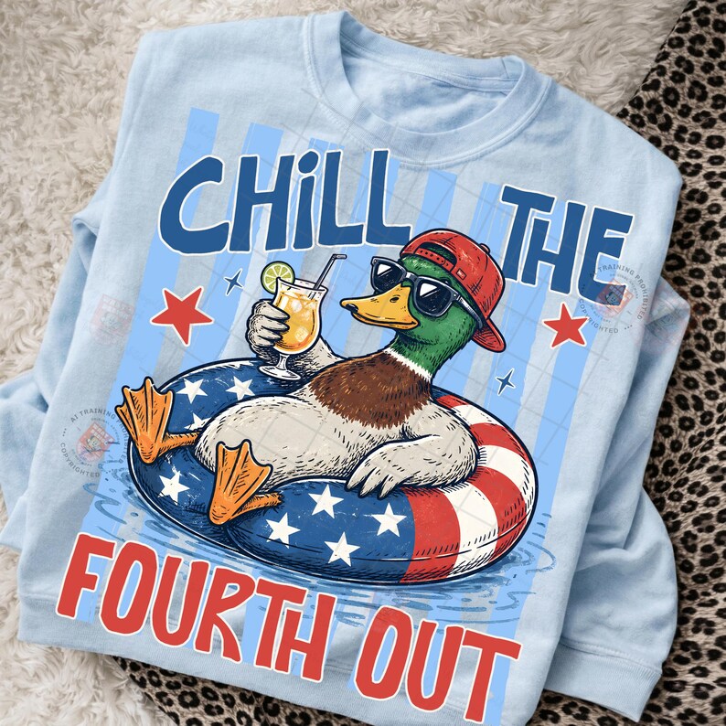 May include: Light blue sweatshirt with a graphic of a duck wearing sunglasses and a red cap, relaxing in a patriotic float with a cocktail. Text reads "CHILL THE FOURTH OUT" in blue and red.