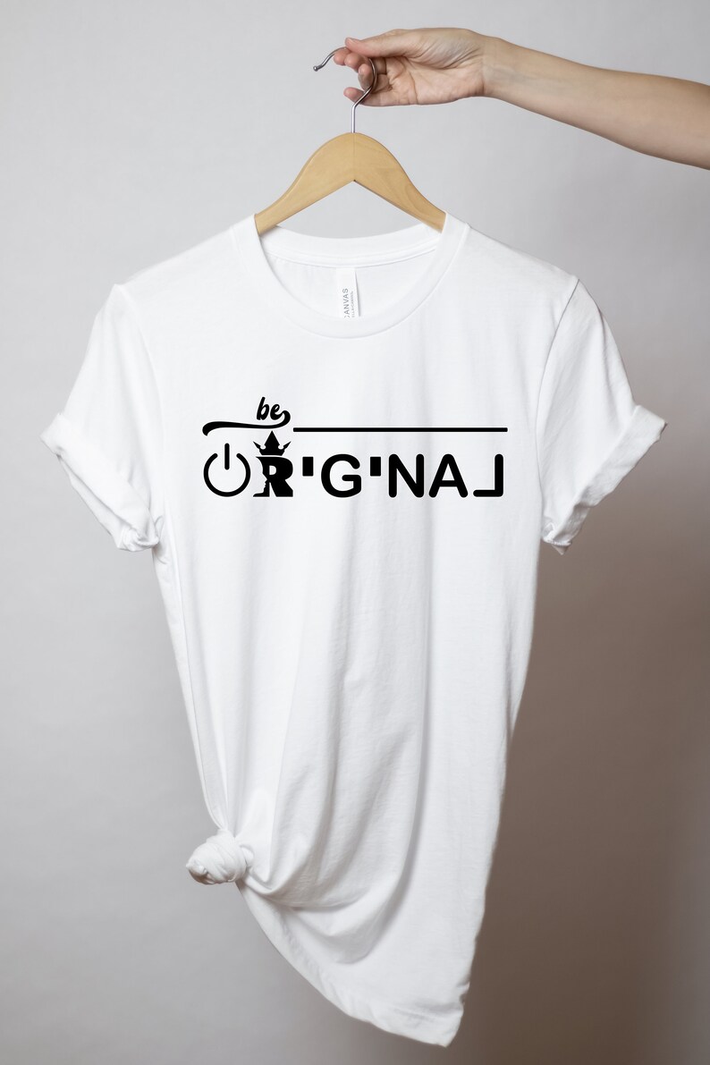 May include: White t-shirt with black text that reads "be ORIGINAL" with a crown and an on/off switch graphic.