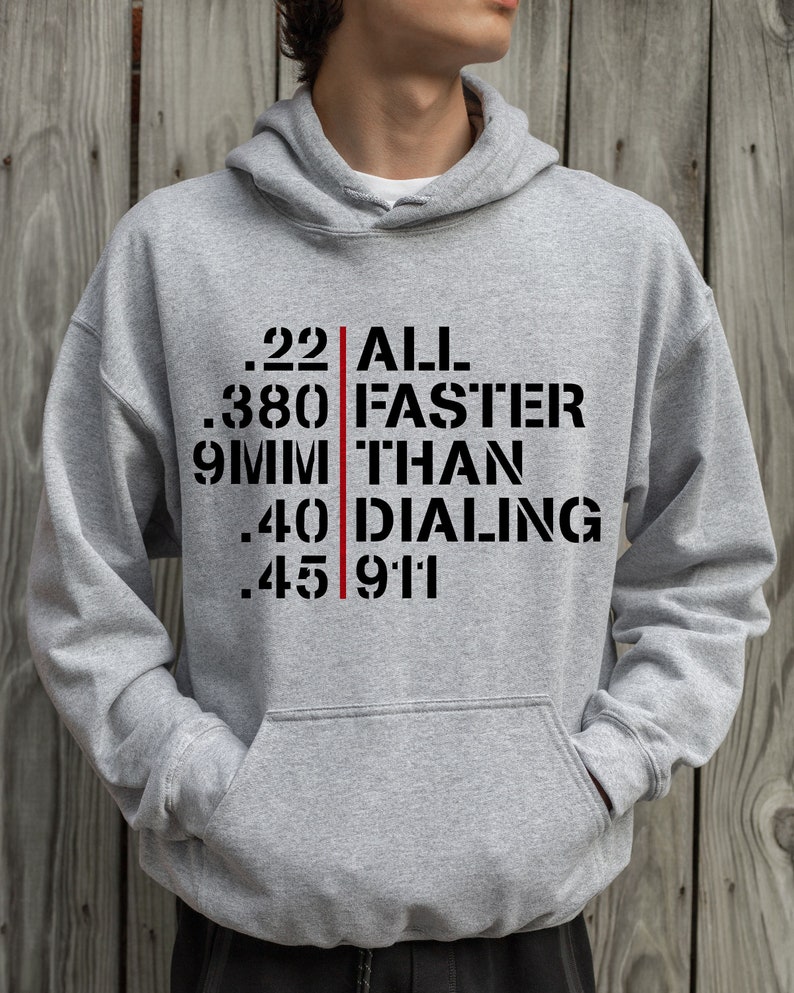 May include: Gray hooded sweatshirt with a black graphic print that reads ".22 ALL .380 FASTER 9MM THAN .40 DIALING .45 911"