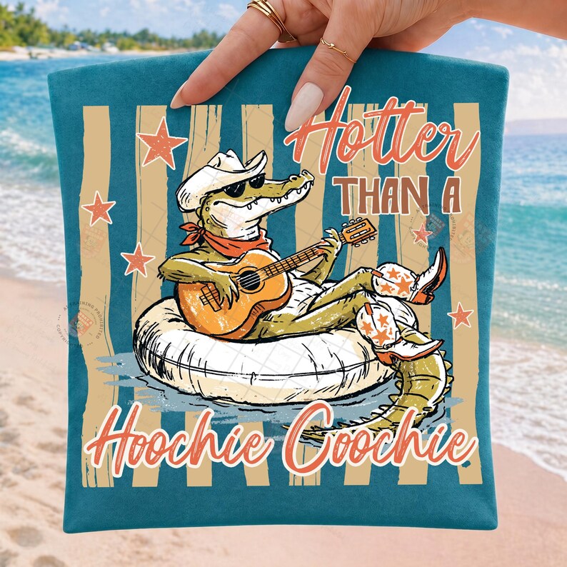 May include: Teal beach towel with a cartoon alligator wearing a cowboy hat and sunglasses, playing a guitar while floating on an inner tube. The text "Hotter Than A Hoochie Coochie" is displayed in orange.