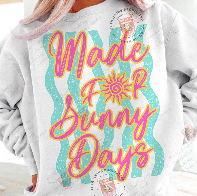 May include: White sweatshirt with the text "Made For Sunny Days" in pink and yellow script. The design includes a yellow sun graphic and turquoise wavy lines. A casual, summery style.