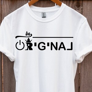 May include: White t-shirt with black text that reads "be original" with a crown and power button graphic.