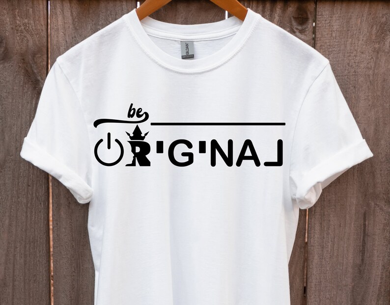 May include: White t-shirt with black text that reads "be original" with a crown and power button graphic.