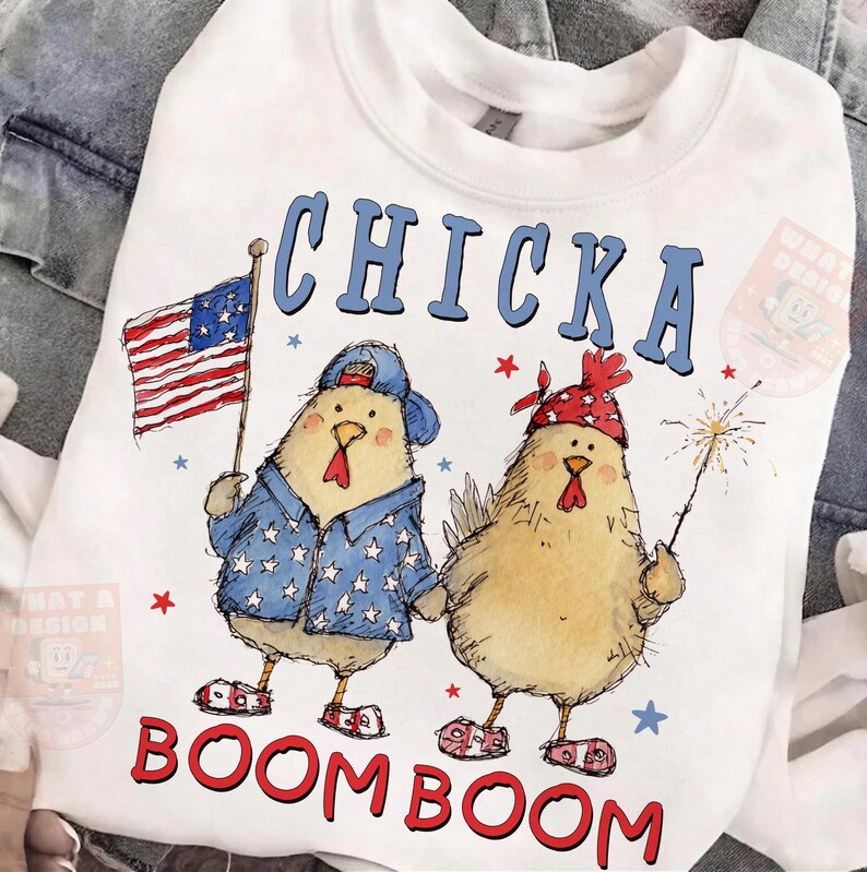May include: White sweatshirt with a graphic of two cartoon chickens. One chicken holds an American flag, the other a sparkler. The text "CHICKA BOOM BOOM" is printed in blue and red.