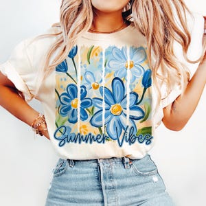 May include: A white t-shirt with a blue and yellow floral design and the text "Summer Vibes".