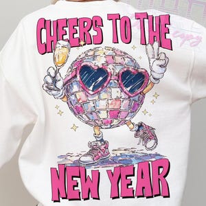 Cheers to the New Year text design with a disco ball character wearing sunglasses and holding champagne