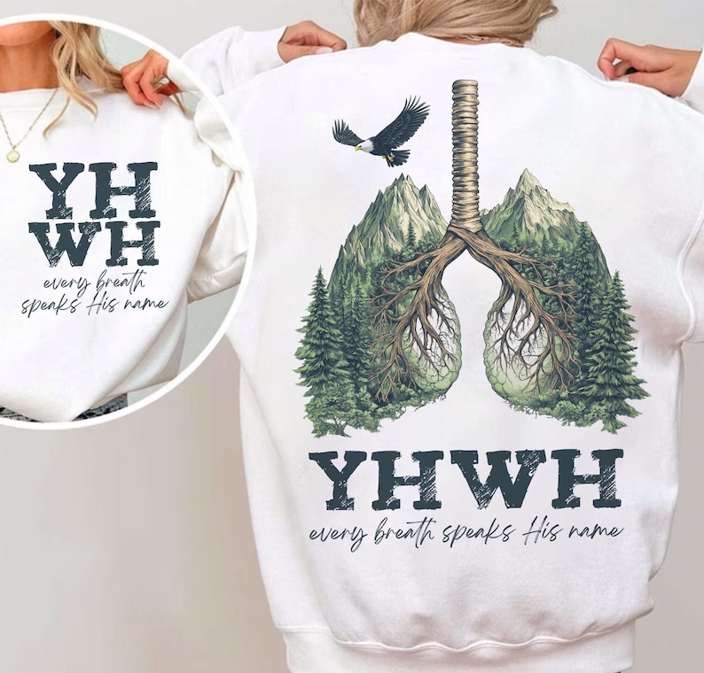 May include: White sweatshirt with a graphic of a pair of lungs made of trees and mountains. The text "YHWH every breath speaks His name" is printed on the sweatshirt.