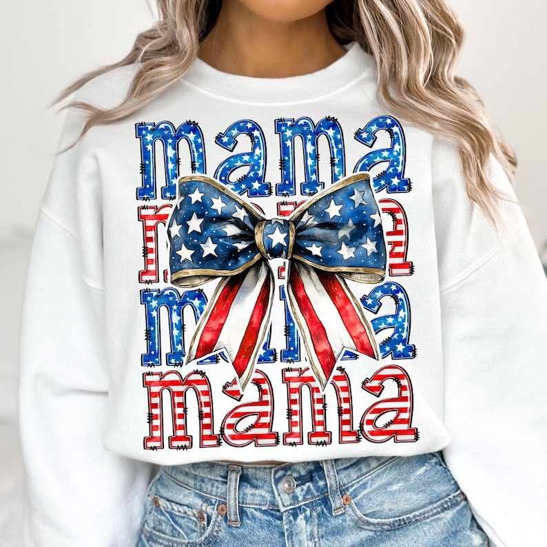 May include: White sweatshirt with the word "mama" repeated three times in blue and red, with a large bow graphic in the center. The bow features a blue background with white stars and red and white stripes.