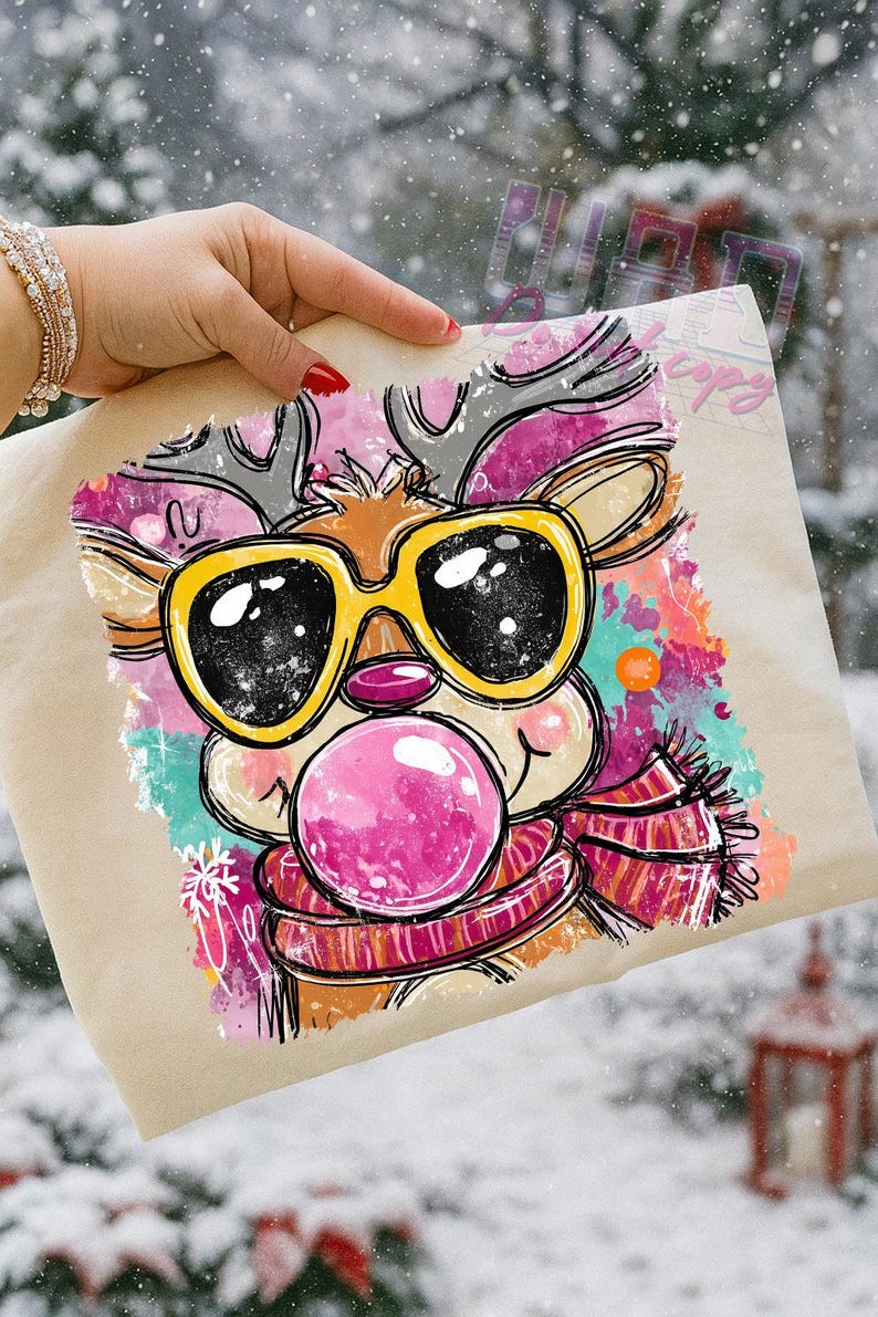 May include: A tan tote bag featuring a cartoon reindeer with yellow sunglasses blowing a pink bubblegum bubble. The reindeer wears a striped scarf and has colorful accents. The image has a winter theme.