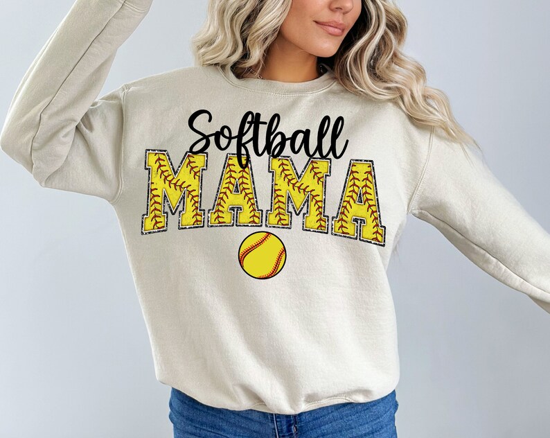 May include: A beige sweatshirt with the text "Softball Mama" in black and yellow with a softball graphic.