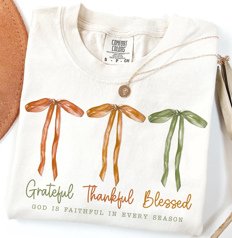 Digital Grateful Thankful Blessed fall PNG design featuring three ribbon bow illustrations in autumn tones.