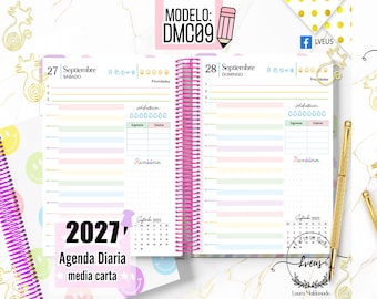 May include: A spiral-bound daily planner open to September 27 and 28, featuring pastel-colored lines, habit trackers, and a September 2025 calendar. The planner includes text such as 'MODELO: DMC09', '2027', and 'Agenda Diaria media carta'.