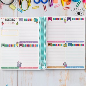 May include: A spiral-bound planner open to a September spread. The left page features the word "Septiembre" and the date. The right page shows the days of the week with colorful illustrations of school supplies. The planner has a teal spiral binding.