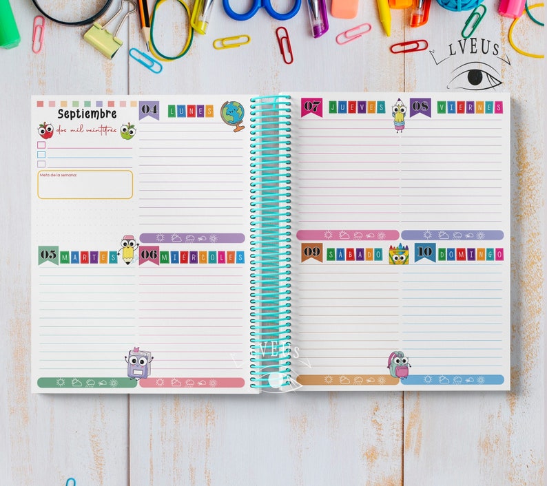 May include: A spiral-bound planner open to a September spread. The left page features the word "Septiembre" and the date. The right page shows the days of the week with colorful illustrations of school supplies. The planner has a teal spiral binding.