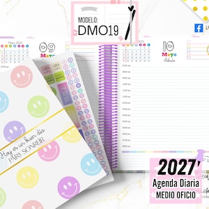 May include: A spiral-bound daily planner featuring a white cover with pastel-colored smiley faces and the text "Hoy es un buen día PARA SONREIR". The interior pages show a May 2025 calendar, hourly schedule, and a sheet of colorful stickers.