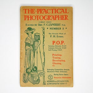 May include: A vintage book cover with a green illustration of a woman holding a camera. The book title is "The Practical Photographer" and the subtitle is "(Library Series)". The book is edited by Rev. F. C. Lambert, MA and is number 5 in the series.