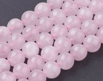 May include: A strand of pale pink rose quartz beads. The beads are round and smooth, with a slightly translucent appearance.