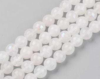 May include: A strand of white iridescent gemstone beads. The beads are round and smooth, with a subtle shimmer.