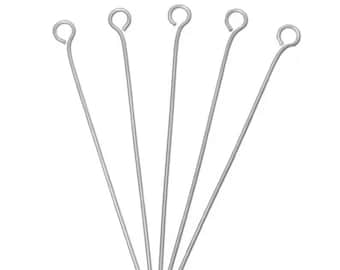 May include: Five silver-colored eye pins, each with a looped top and a straight wire shaft. The pins are arranged in a fan-like pattern against a white background, suitable for jewelry making or crafting.