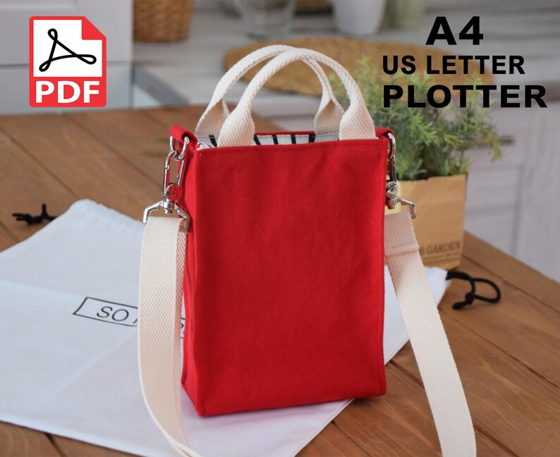 May include: Red canvas tote bag with white straps and a zipper closure. The bag has a long strap for carrying it over the shoulder. The bag is labeled "A4 US LETTER PLOTTER" and is available as a PDF download.