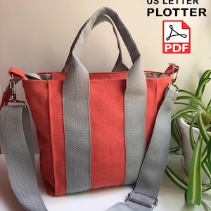以下が含まれることがあります： コーラル色のキャンバス地のトートバッグで、グレーのストラップが付いています。バッグにはトップハンドルと、長さ調節可能な長いショルダーストラップが付いています。バッグは丈夫なキャンバス地で作られており、シンプルでクラシックなデザインです。A4 US Letter Plotter PDF.