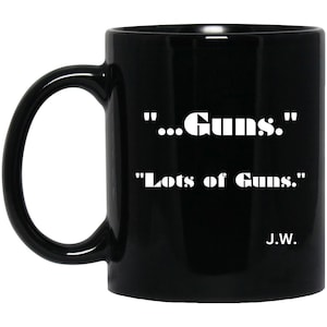 May include: Black ceramic mug with a white handle. The mug features the text "...Guns." and "Lots of Guns." in a bold, white font. The initials "J.W." are printed below the text. A simple, yet bold design.