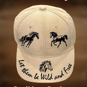 May include: A beige baseball cap with black horse silhouettes and the text "Let them be Wild and Free." The cap also features the text "For Hand Burning" and "CoolMoonDesigns."